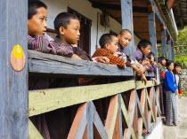 Bhutan, Mongar, Schoolchildren standing outside class.