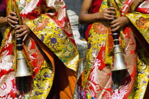Bhutan, Bumthang District, Tamshing Lhakang, Buddhist pipe players dressed in ceremonial silk robes.