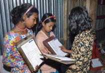 Bangladesh, Chittagong, Comilla, BRAC students in a  primary classroom with peer marking.