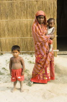 Bangladesh, Dhaka Division, Tangail Sadar Upazila, Mother and children on the impoverished chars, beside the Brahmaputra river.