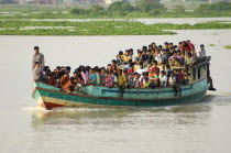 Bangldesh, Dhaka Division, Keraniganj Upazila, Overcrowded boat travelling down a tributary river.