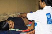 Bangladesh, Chittagong, Khagrachari, Pregnant mother being examined by UNDP nurse.