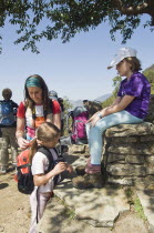 Nepal, Pokhara. Western family with children resting during trek in Nepali Himalayan hills near Pokhara.