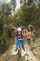 Nepal, Pokhara. Western family with children trekking in Nepali Himalayan hills near Pokhara.