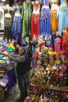 Turkey, Istanbul, Fatih, Sultanahmet, Kapalicarsi, Stall selling traditional clothing in the Grand Bazaar.