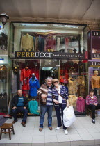 Turkey, Istanbul, Fatih, Sultanahmet, Kapalicarsi, Customer and owner of Ferrucci's Leather Wear and Fur Store in the Grand Bazaar.