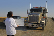 Canada, Alberta, Blood Reserve, Fracking for oil and gas on the Blood Tribe Indian  Reserve at the edge of the Baaken play. Anti-fracking protestor Lois Frank blocks a GASFRAC truck engaged in frackin...
