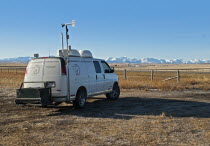 Canada, Alberta, Blood Reserve, Fracking for oil and gas on the Blood Tribe Indian  Reserve at the edge of the Baaken play. Oil company environmental air quality monitoring van woth drilling site and...