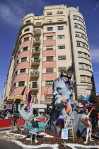 Spain, Valencia Province, Valencia,Typical falla scene with papier mache figures in the street during Las Fallas festival.