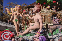 Spain, Valencia Province, Valencia, Papier Mache figures of Adam and Eve in the garden during Las Fallas festival.