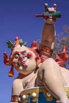 Spain, Valencia Province, Valencia, Grotesque Papier Mache figure at the Serranos Towers during Las Fallas festival.