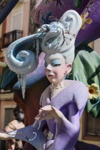 Spain, Valencia Province, Valencia, Papier Mache figure of well dressed lady in the street during Las Fallas festival.