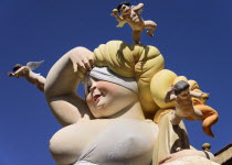 Spain, Valencia Province, Valencia, Falla scene with Papier Mache close up of a lady surrounded by cherubs at Torres de Quart during Las Fallas festival.