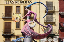 Spain, Valencia Province, Valencia, Papier Mache figure of a lady in a pink dress holding a replica of the sun during Las Fallas festival.