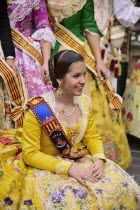 Spain, Valencia Province, Valencia, Reina Fallera in traditional Valencian costume taking a break during Las Fallas festival.