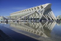 Spain, Valencia Province, Valencia, La Ciudad de las Artes y las Ciencias, City of Arts and Sciences, City of Arts and Sciences, Principe Felipe Science Museum with row of Mercedes cars on display.