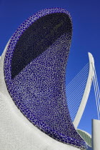 Spain, Valencia Province, Valencia, La Ciudad de las Artes y las Ciencias, City of Arts and Sciences, An arch of the Umbracle sculpture garden with El Pont de l'Assut de l'Or bridge in the background.