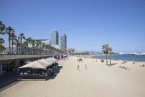 Spain, Catalonia, Barcelona, Barceloneta, Playa de St Sebastia, view along beach toward Port Olimpic.