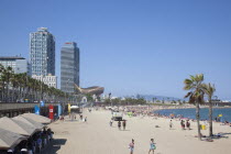 Spain, Catalonia, Barcelona, Barceloneta, Playa de St Sebastia, view along beach toward Port Olimpic.