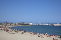 Spain, Catalonia, Barcelona, Barceloneta, Playa de St Sebastia, view along beach toward Port Olimpic.