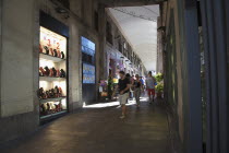 Spain, Catalonia, Barcelona, La Rambla, tourist in shopping arcade next to La Boqueria market.