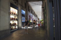 Spain, Catalonia, Barcelona, La Rambla, tourist in shopping arcade next to La Boqueria market.