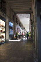 Spain, Catalonia, Barcelona, La Rambla, tourist in shopping arcade next to La Boqueria market.