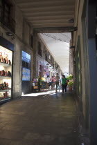 Spain, Catalonia, Barcelona, La Rambla, tourist in shopping arcade next to La Boqueria market.