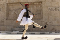 Greece, Attica, Athens, Greek soldier, Evzone, marching beside Tomb of the Unknown Soldier, outside Parliament building.