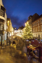 England, Hampshire, Winchester, High street decorated with Christmas tree and decorations, seen from the Buttercross.