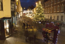 England, Hampshire, Winchester, High street decorated with Christmas tree and decorations, seen from the Buttercross.