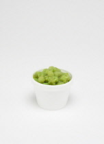Food, Cooked, Vegetables, Green mushy peas in an insulated polystyrene foam container on a white background.