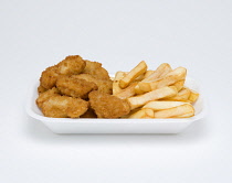 Food, Cooked, Seafood, fried scampi in batter and potato chips in an insulated polystyrene foam tray on a white background.