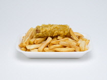Food, Cooked, Meat, A single battered pork sausage with potato chips in an insulated polystyrene foam tray on a white background.