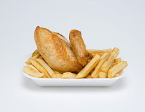 Food, Cooked, Poultry, Fried chicken quarter and potato chips in an insulated polystyrene foam tray on a white background.