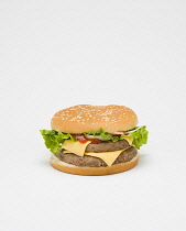 Food, Cooked, Meat, Double cheesburger with salad and tomato ketchup in a bun on a white background.