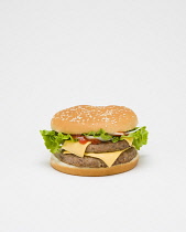Food, Cooked, Meat, Double cheesburger with salad and tomato ketchup in a bun on a white background.