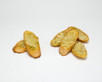 Food, Cooked, Bread, Slices of baguette with melted cheese on a white background.