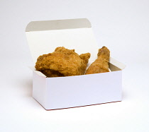 Food, Cooked, Poultry, Battered chicken breast fillet and drumstick in a cardboard box on a white background.