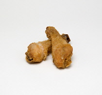 Food, Cooked, Poultry, Two battered chicken drumsticks on a white background.