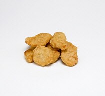 Food, Cooked, Poultry, Group of battered chicken nuggets on a white background.