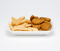 Food, Cooked, Vegetables, Mixed vegetables in bread crumbs with potato chips in a foam polystyrene tray on a white background.