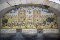 Spain, Catalonia, Barcelona, Drinking water fountain in Portaferrissa Street off La Rambla in the Gothic Quarter with a tiled depiction of one of the gates to the old walled city.