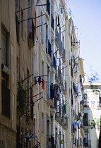 Spain, Catalonia, Barcelona, Washing hanging from windows of an apartment building in the Gothic Quarter district.