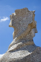 Spain, Catalonia, Barcelona, Chimneys and vents on the roof of Casa Mila apartment building known as La Pedrera or Stone Quarry designed by Antoni Gaudi in the Eixample district.