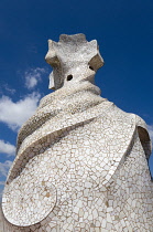 Spain, Catalonia, Barcelona, Chimneys and vents on the roof of Casa Mila apartment building known as La Pedrera or Stone Quarry designed by Antoni Gaudi in the Eixample district.