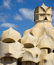 Spain, catalonia, Barcelona, Chimneys and vents on the roof of Casa Mila apartment building known as La Pedrera or Stone Quarry designed by Antoni Gaudi in the Eixample district.
