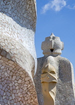 Spain, Catalonia, Barcelona, Chimneys and vents on the roof of Casa Mila apartment building known as La Pedrera or Stone Quarry designed by Antoni Gaudi in the Eixample district.