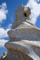 Spain, Catalonia, Barcelona, Chimneys and vents on the roof of Casa Mila apartment building known as La Pedrera or Stone Quarry designed by Antoni Gaudi in the Eixample district.