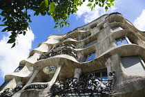 Spain, Catalonia, Barcelona, Facade of Casa Mila apartment building known as La Pedrera or Stone Quarry designed by Antoni Gaudi in the Eixample district.